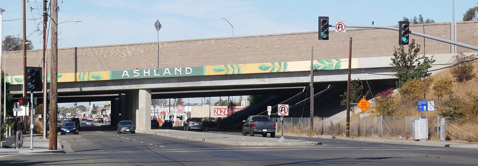An Ashland welcome sign on a freeway overpass above East 14th Street