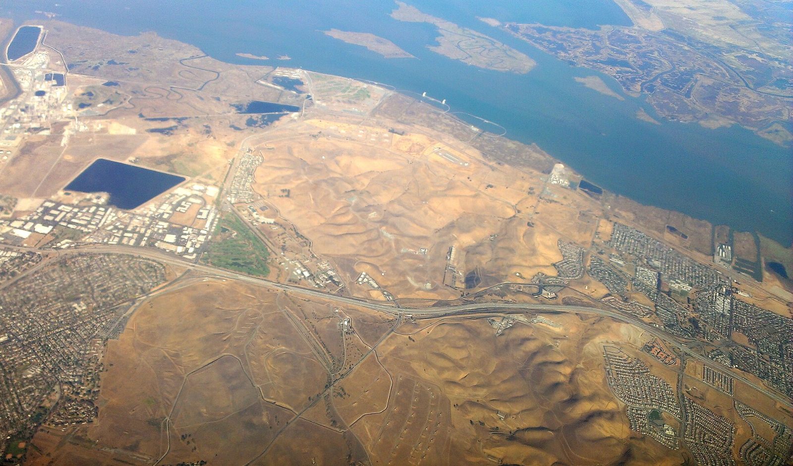 Aerial view of the Suisun Bay shoreline and the former Port Chicago naval base near Bay Point