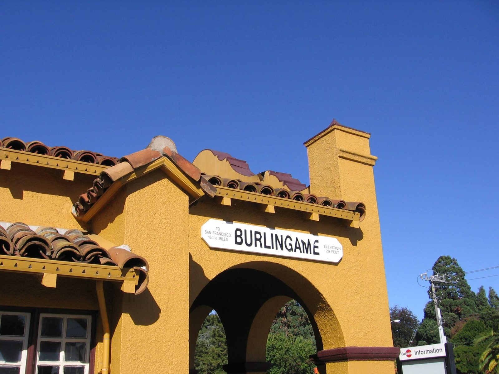 The yellow 1894 Burlingame train station with its mission-style tower