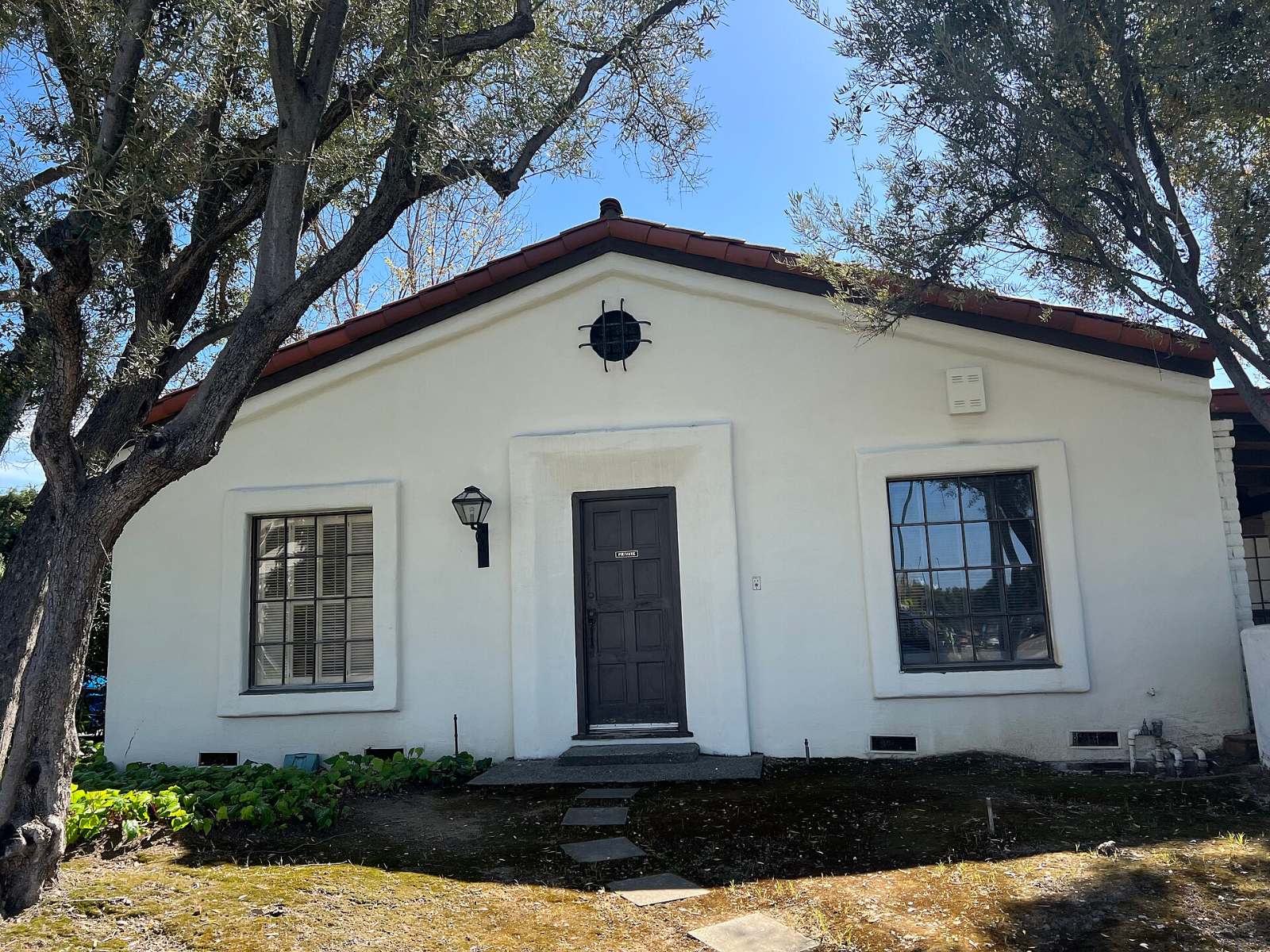 A single-story home with a tree in the front yard in Cambrian