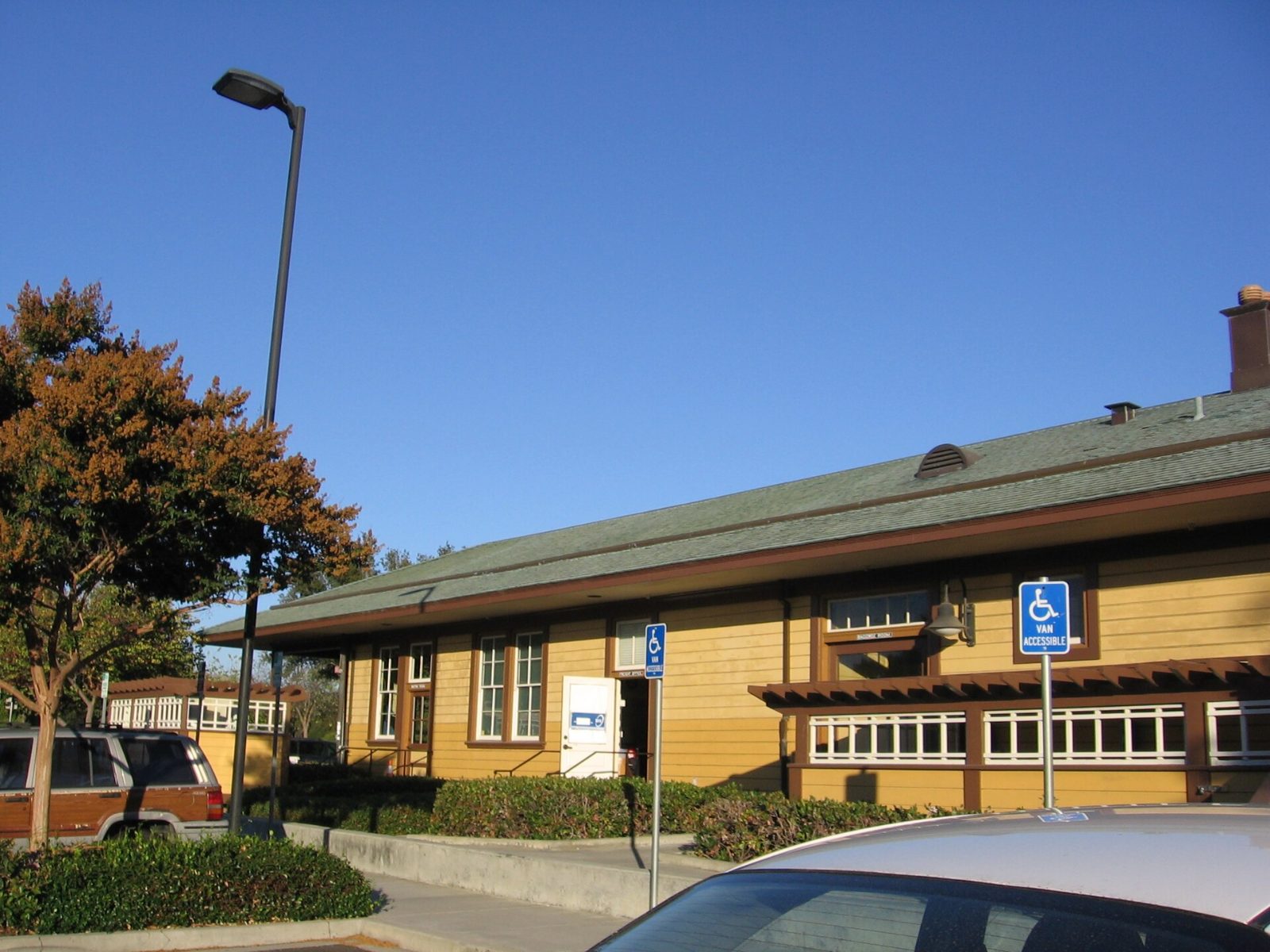 The yellow wooden Centerville train depot with its long roof