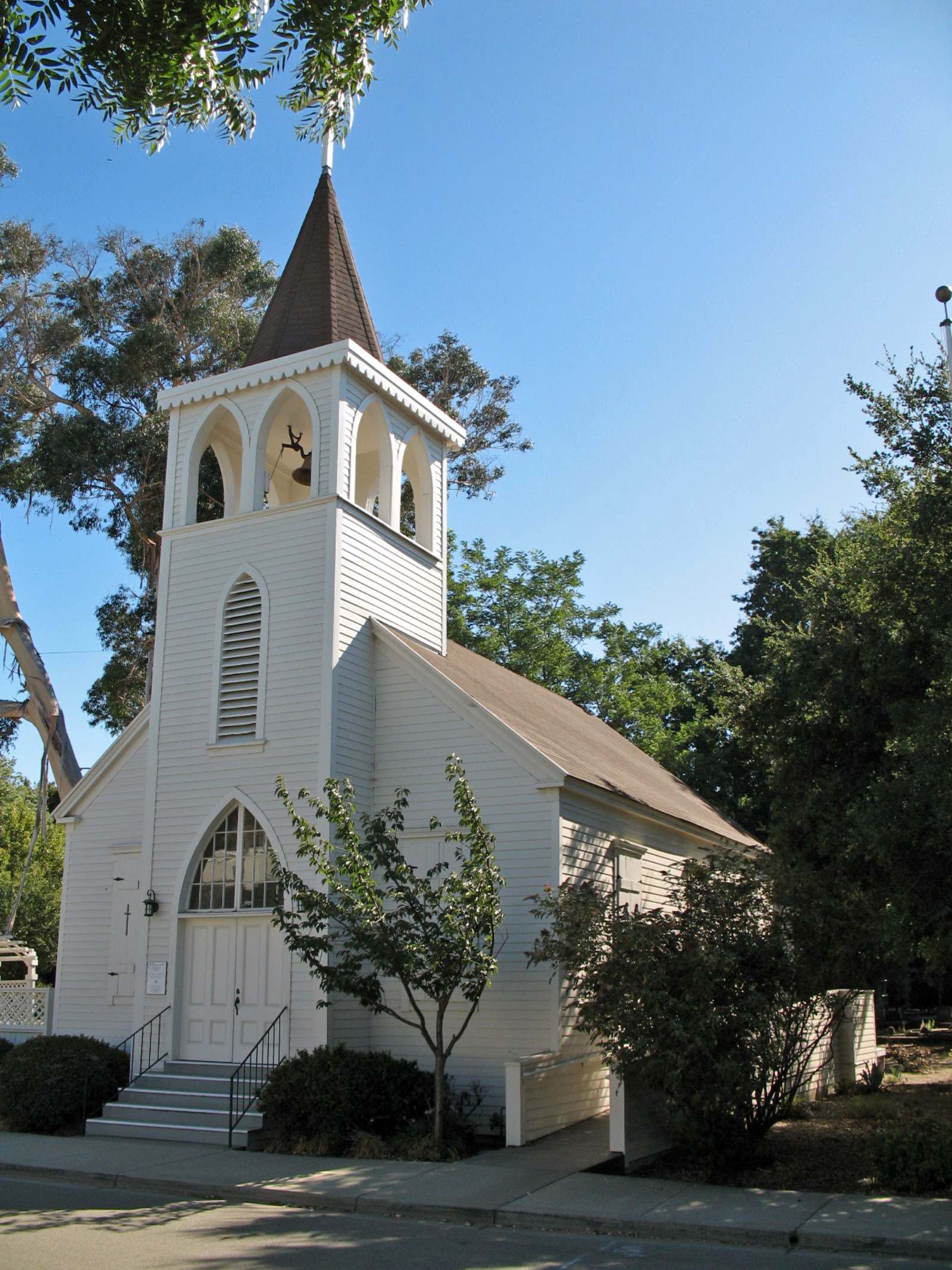 Old St. Raymond’s Church, a small white wooden church with a bell tower