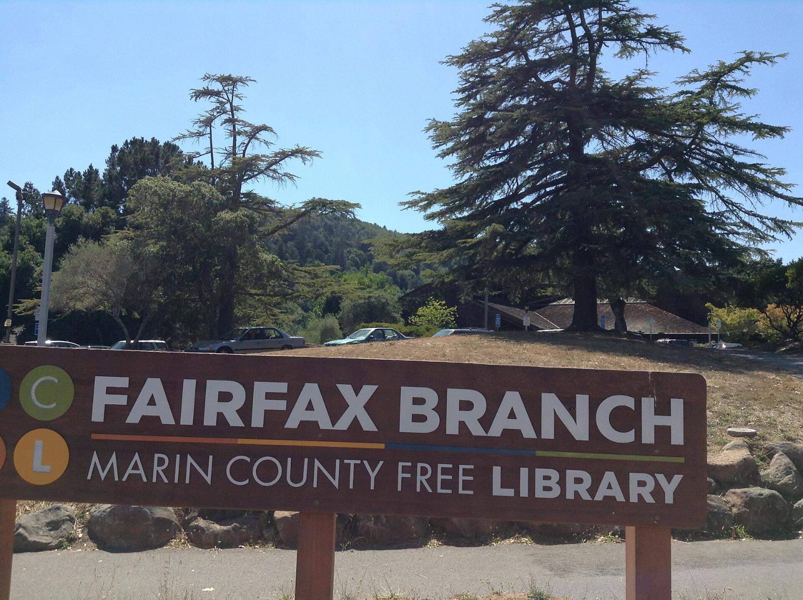 The sign for the Fairfax branch of the Marin County Free Library among trees
