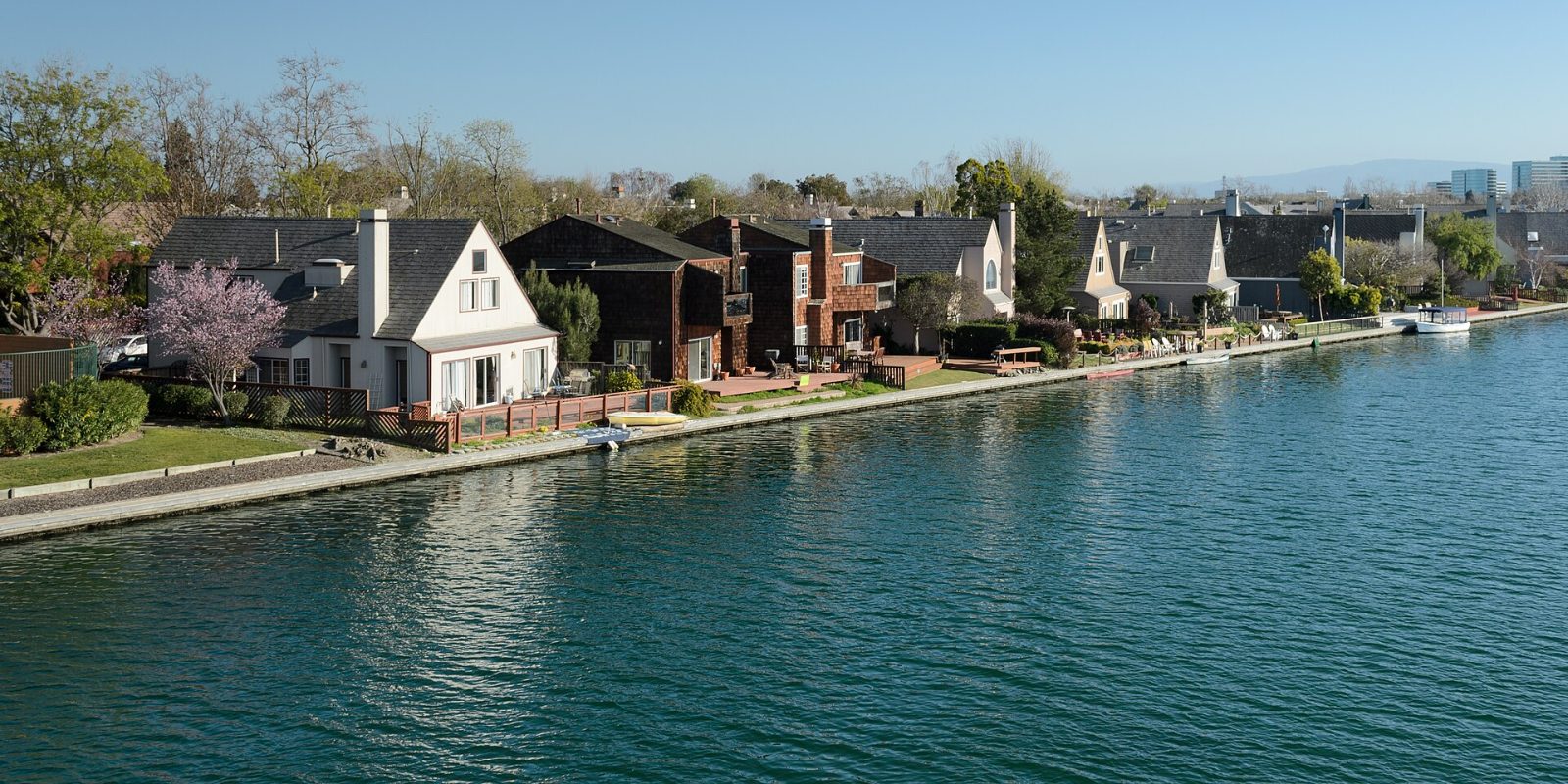 Homes lining the lagoon in Foster City with boats on the water