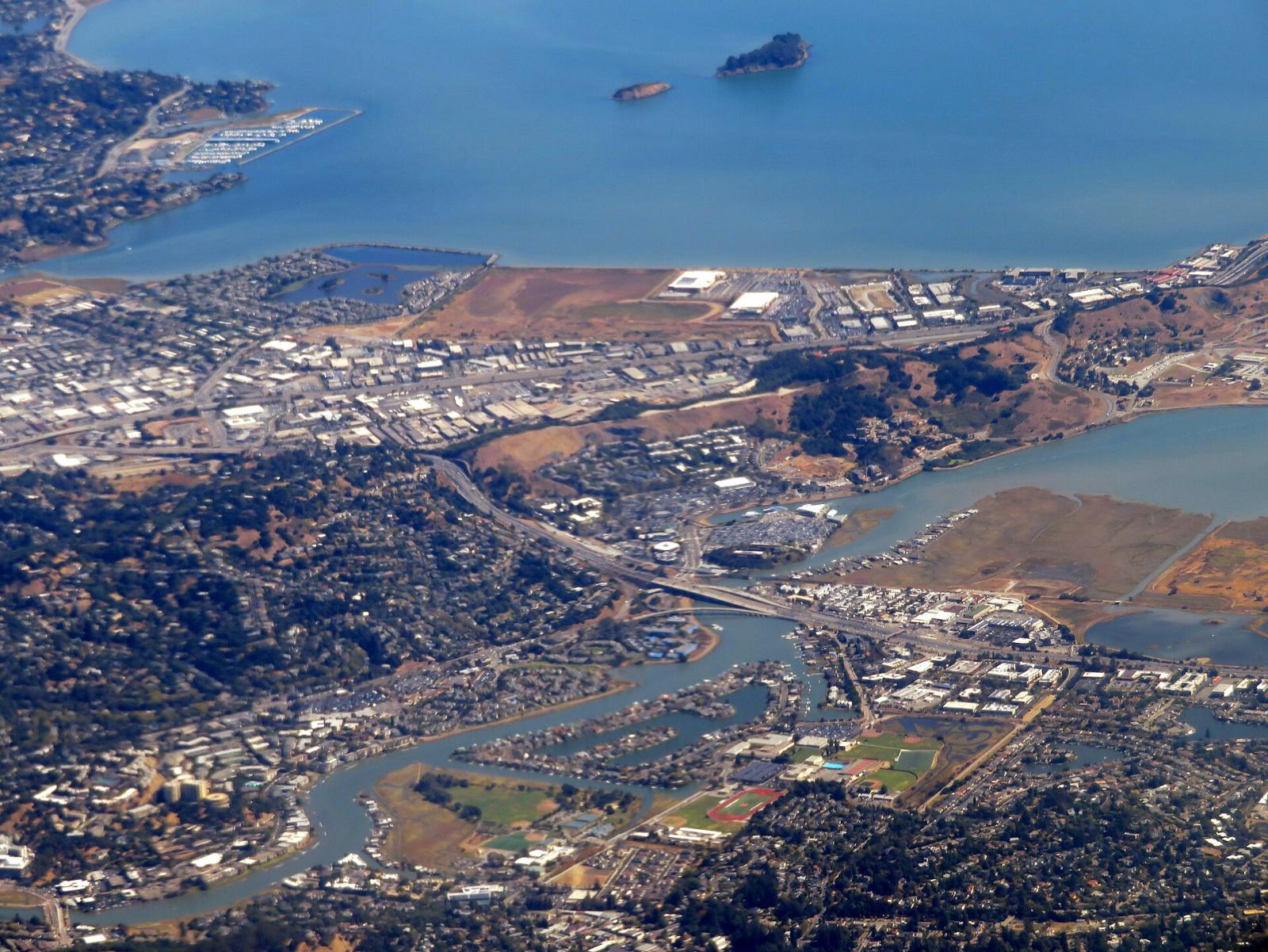 Aerial view of Greenbrae with homes, trees and the bay