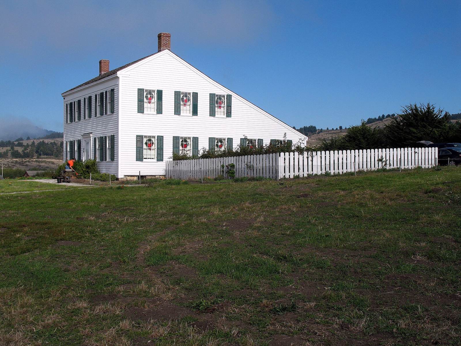 The white James Johnston House on a hill in Half Moon Bay