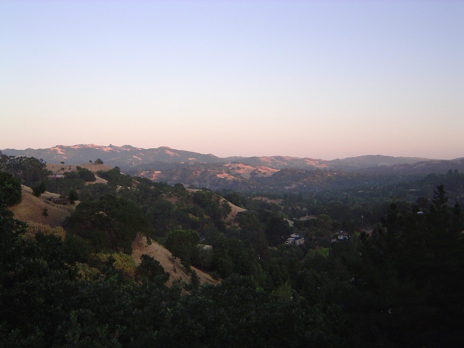 Green hills and trees around Lafayette under a clear sky
