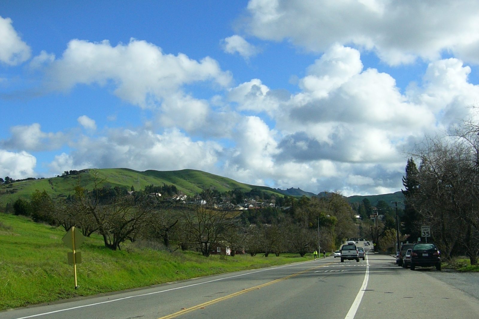 A road through Moraga with green hills and trees