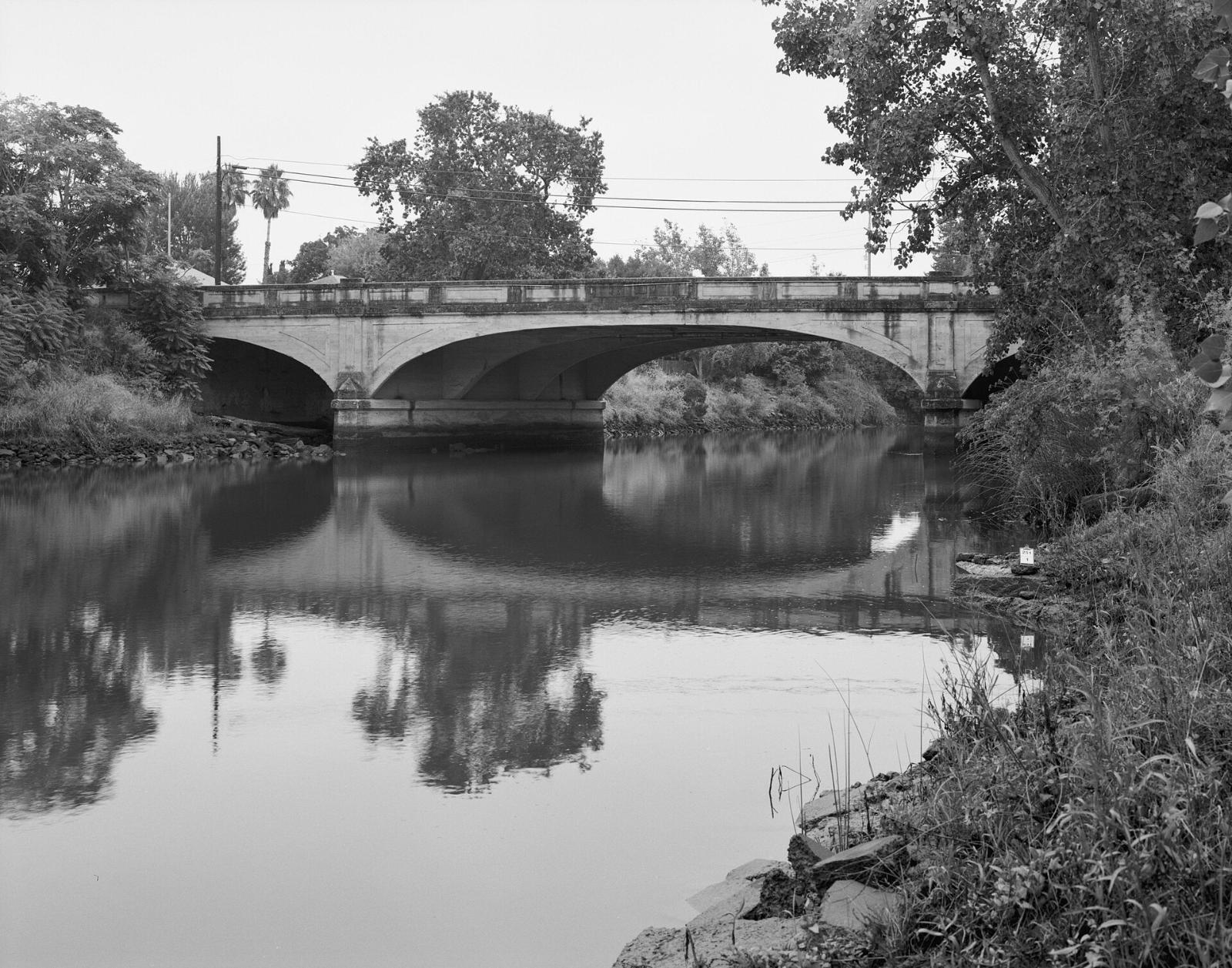 Black and white photo of the arched First Street Bridge over the Napa River