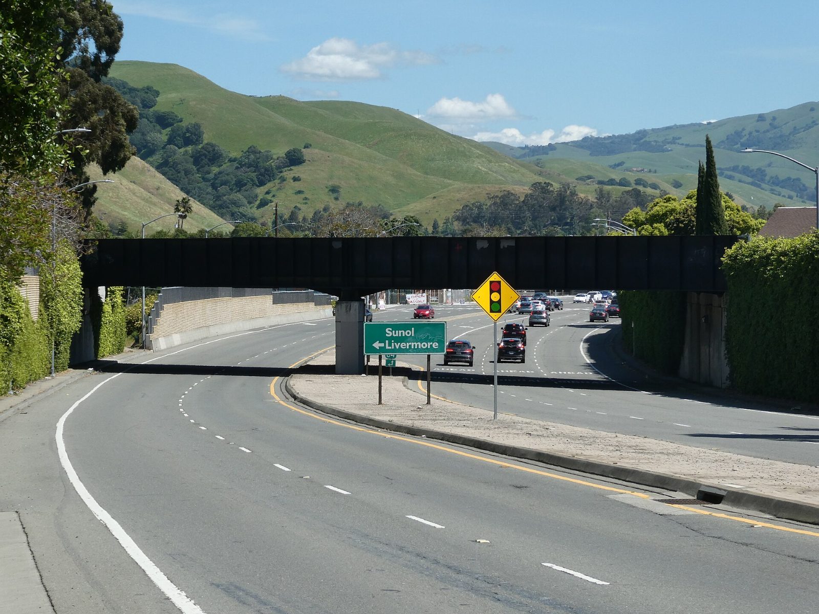 The Niles Canyon Railway bridge crossing Mission Boulevard below green hills