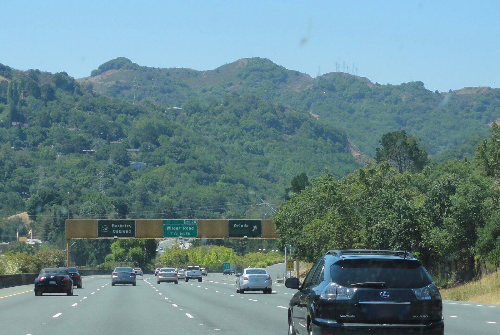Rolling green hills and trees in Orinda below the Berkeley Hills