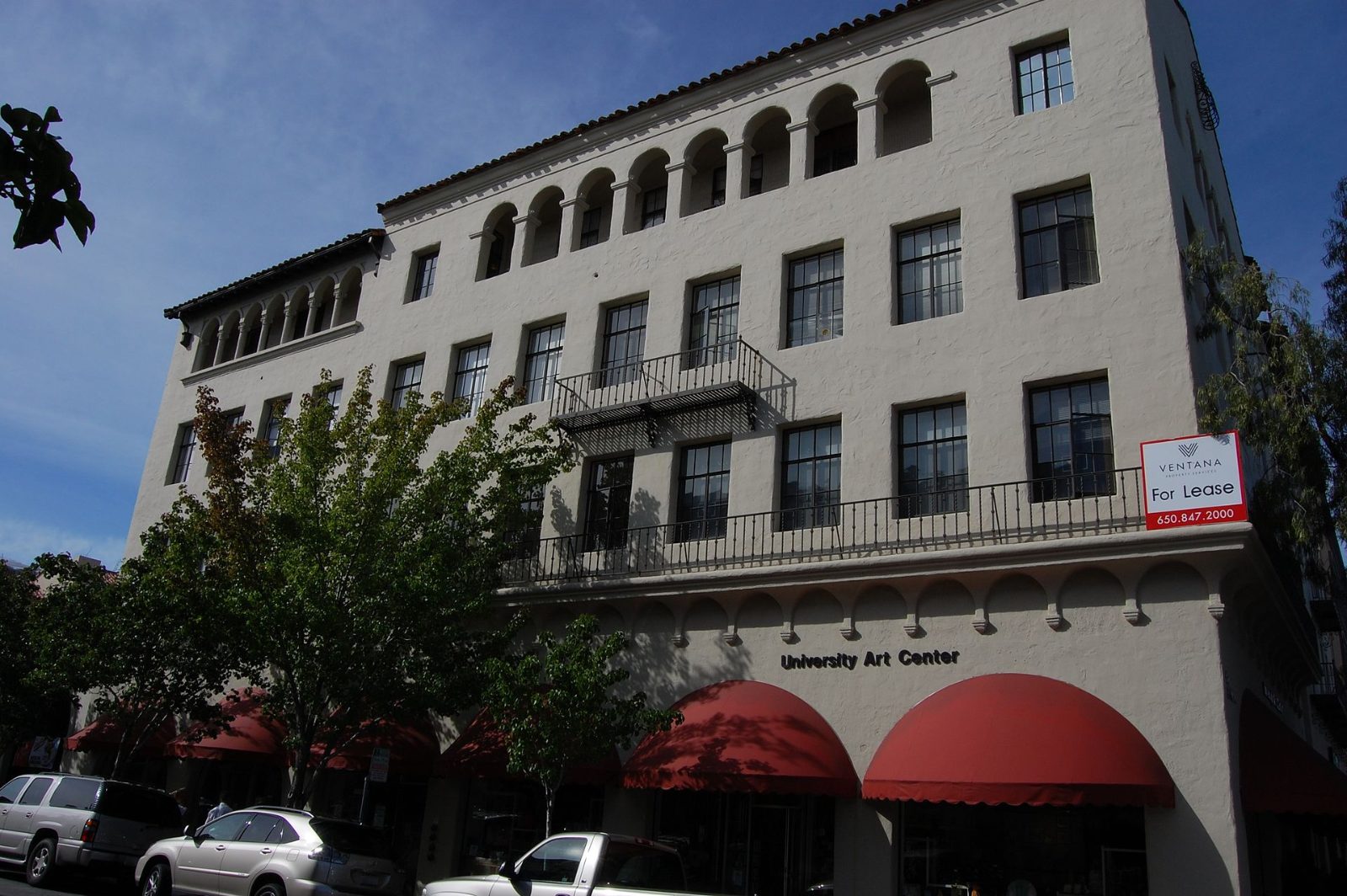 Historic Spanish Revival buildings with striped awnings on Ramona Street in downtown Palo Alto