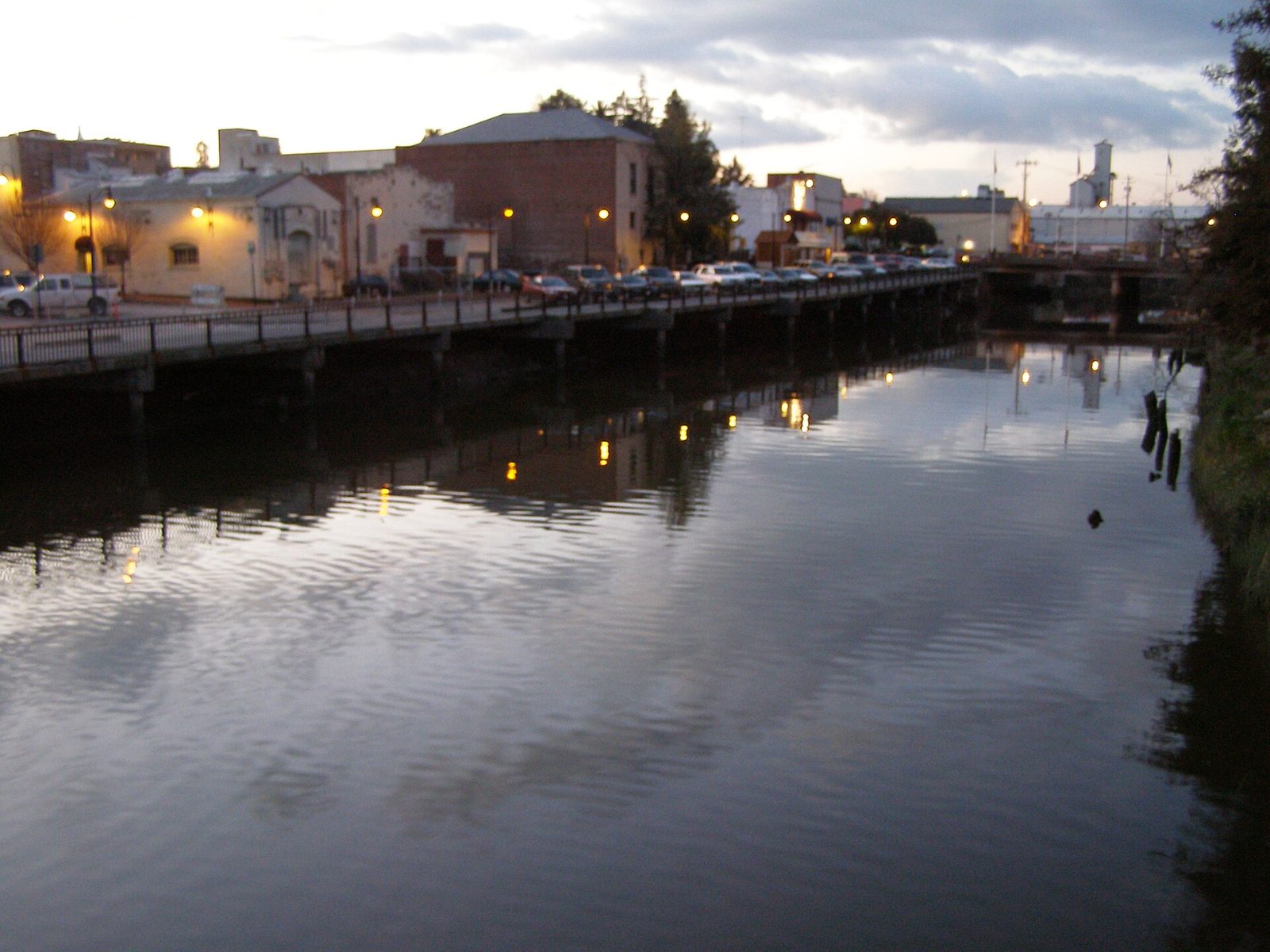 The Petaluma River and waterfront buildings seen from a downtown footbridge