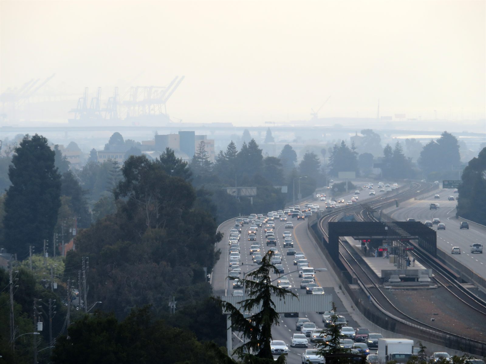 Rockridge BART station with Oakland port cranes in the distance