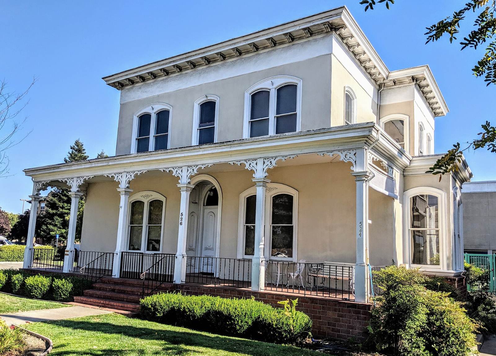 A two-story historic house with a wide front porch in San Lorenzo