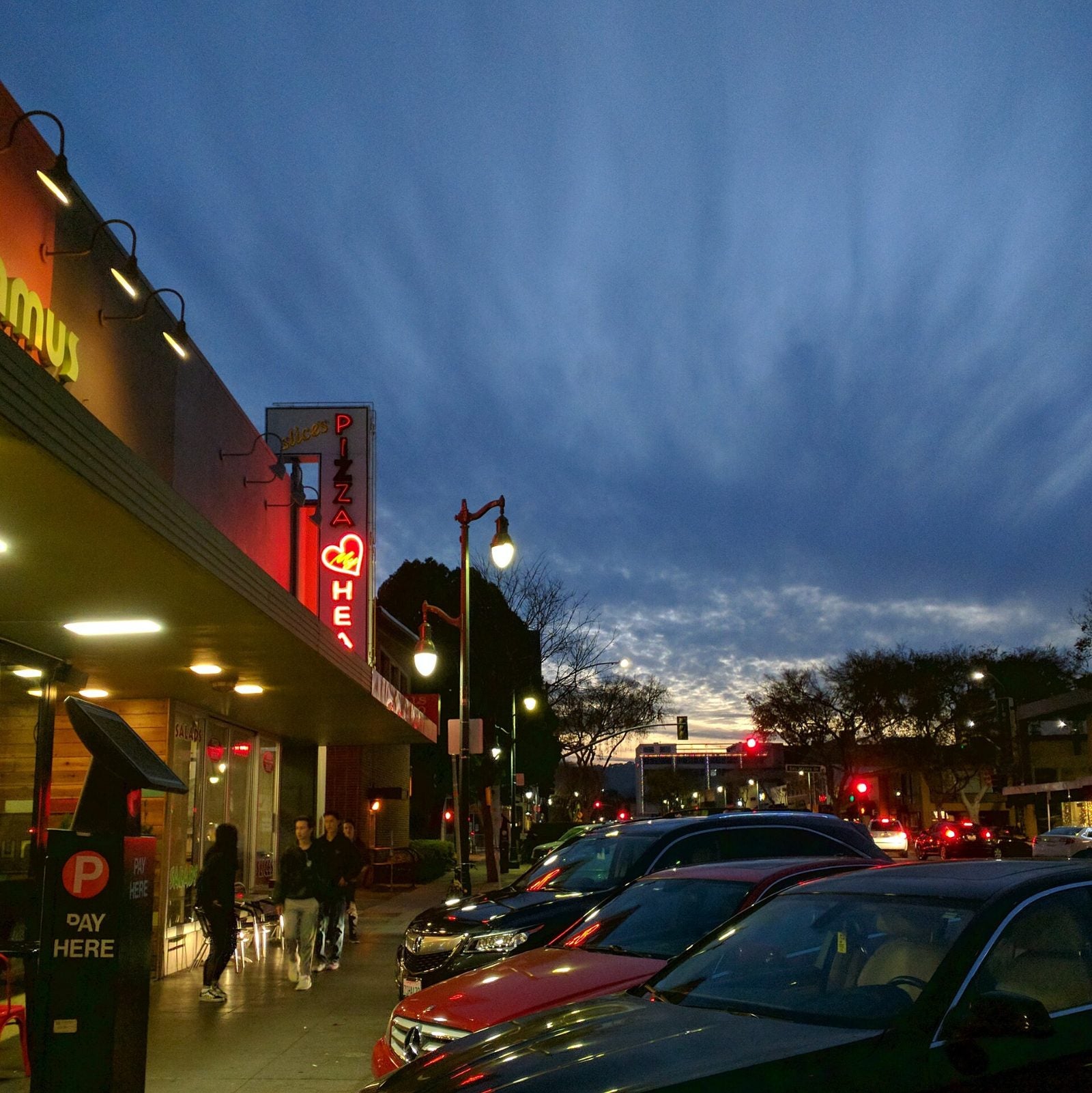 Shops and restaurants lit up in downtown San Mateo at dusk