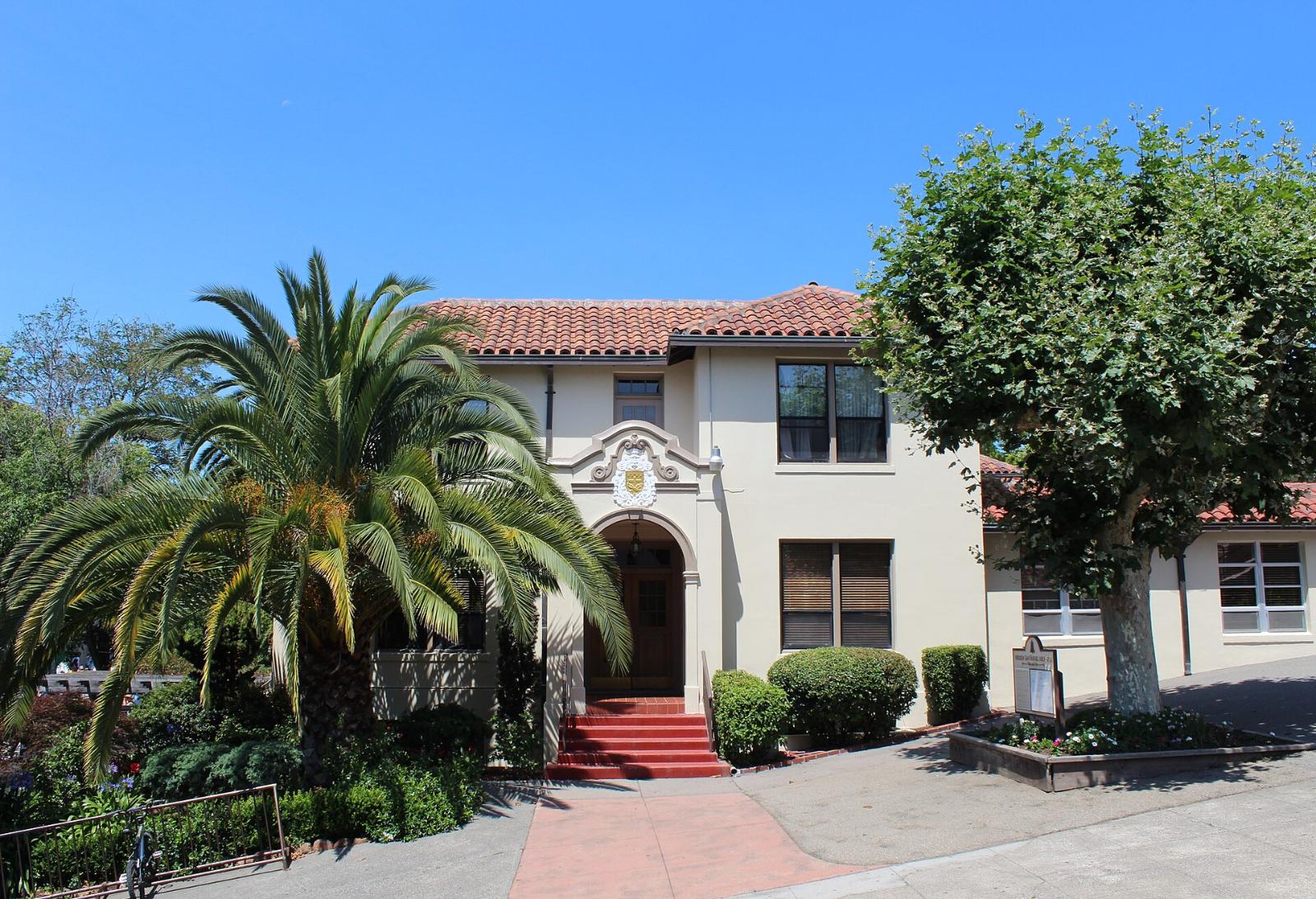 The white chapel of Mission San Rafael Arcángel with its bell and red tile roof