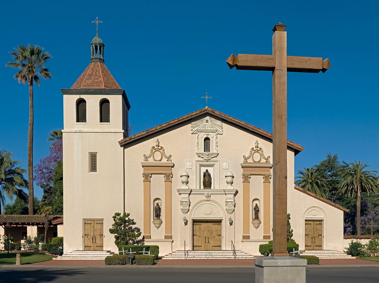 The painted front and bell tower of Mission Santa Clara de Asís