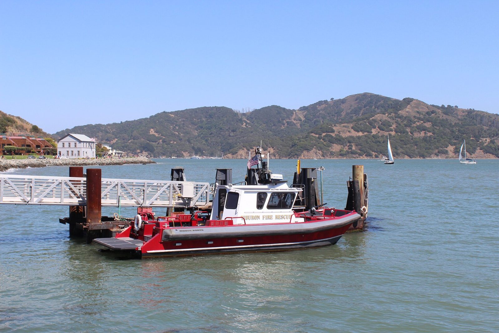 A ferry boat at the Tiburon dock with Angel Island behind it