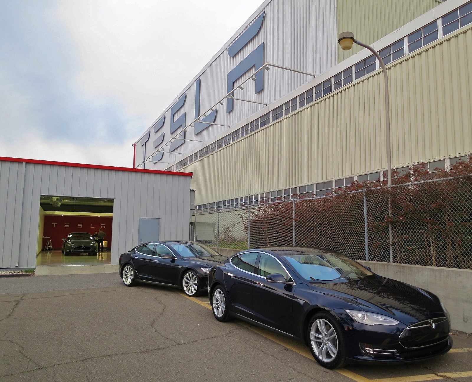 New cars parked outside the Tesla factory in Fremont