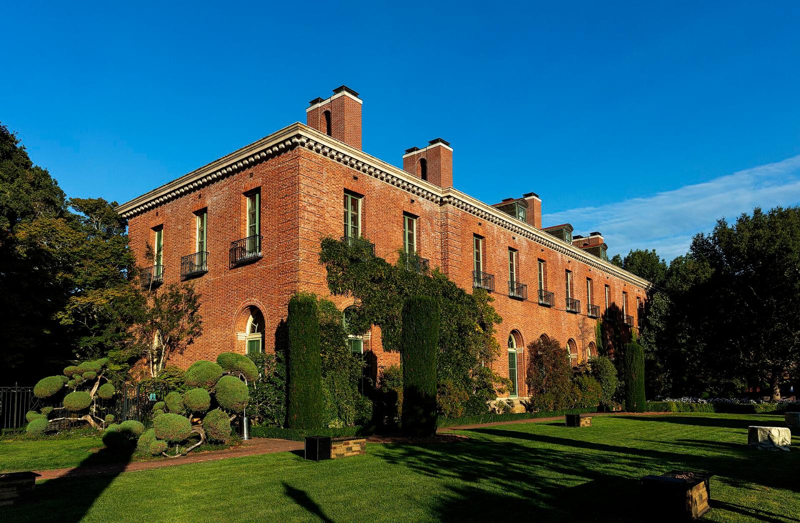 The brick Filoli mansion seen across lawns and trees